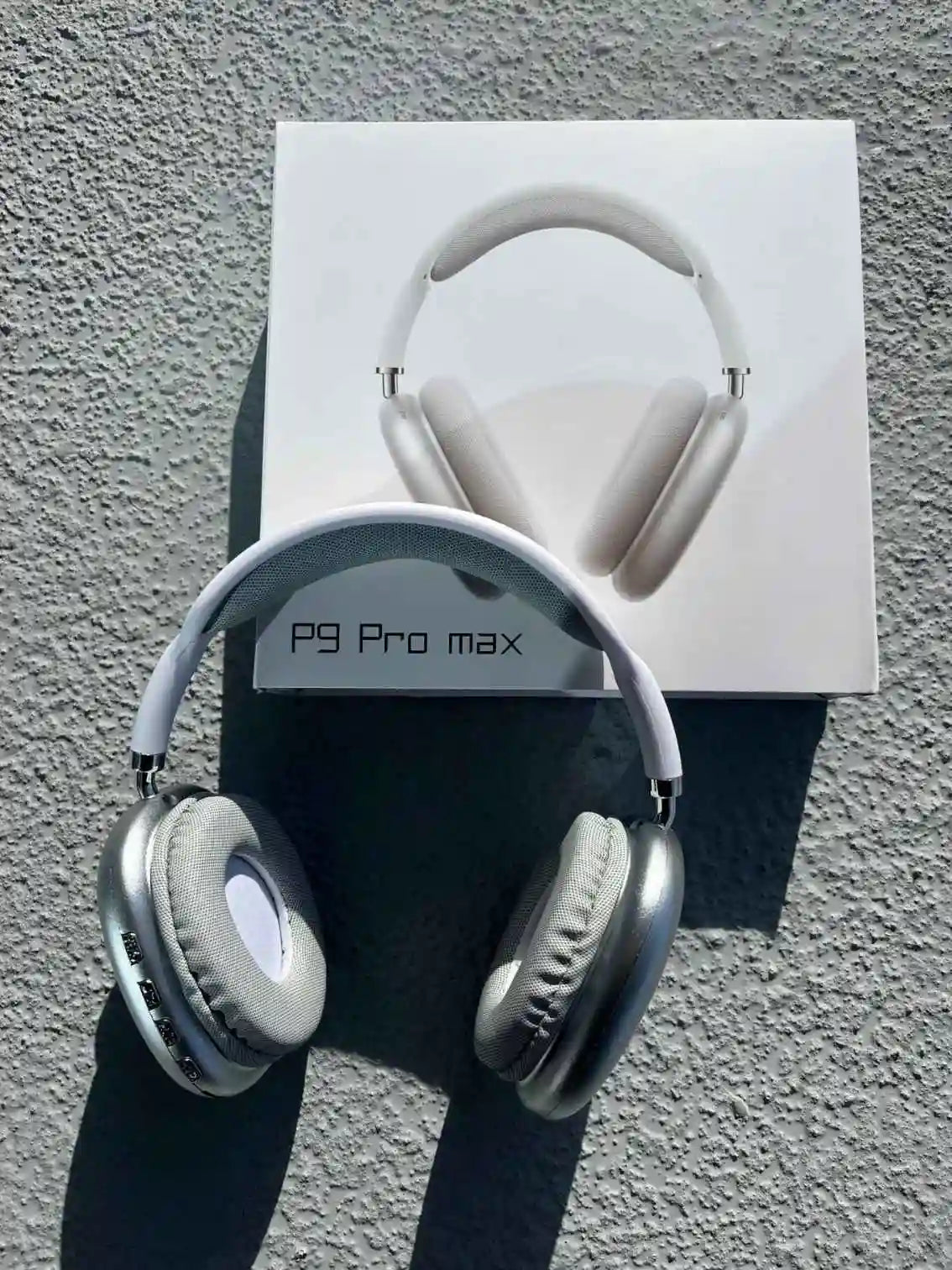 Silver over-ear Bluetooth Pro Max p9 headphones on the box.