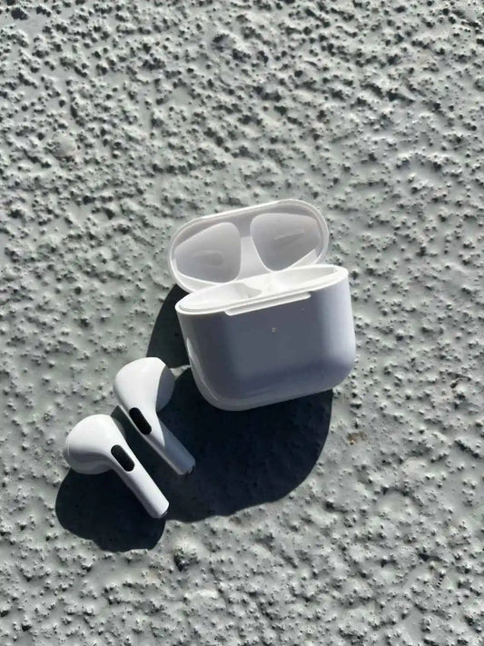 Pro 4 white wireless earbuds in open charging case.