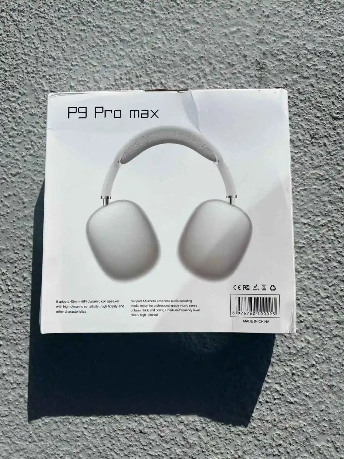 White and silver wireless headphones in packaging.