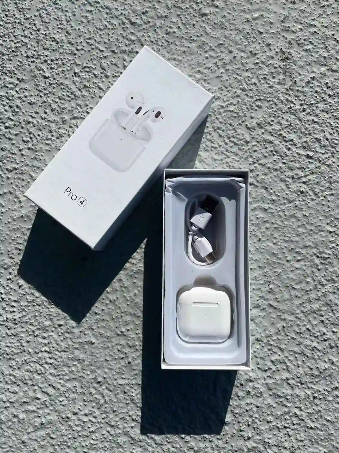 Pro 4 white wireless earphones with charging case, sleek and compact design.