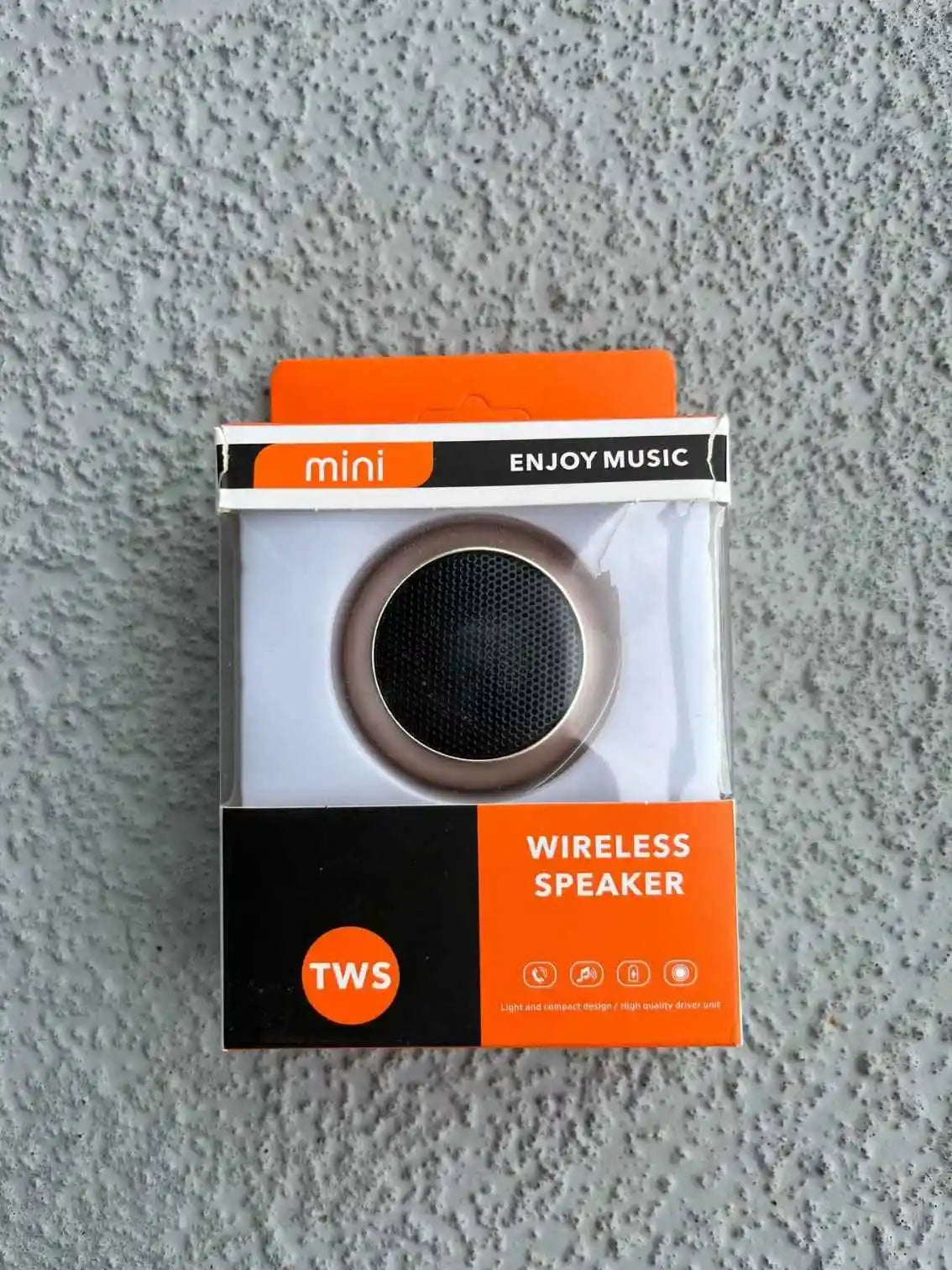 Mini rose gold Bluetooth speaker in packaging.