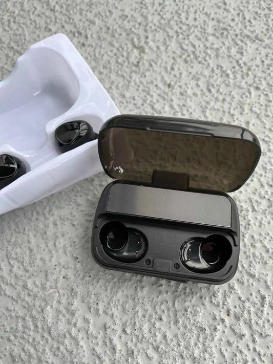 Unboxing of wireless earbuds and charging case, showcasing compact design and sleek packaging.
