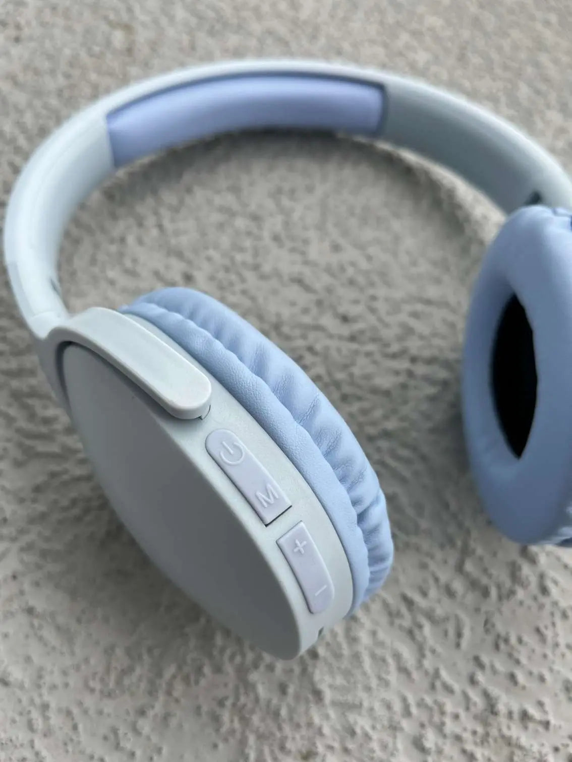 Blue wireless headphones with close-up of control buttons.