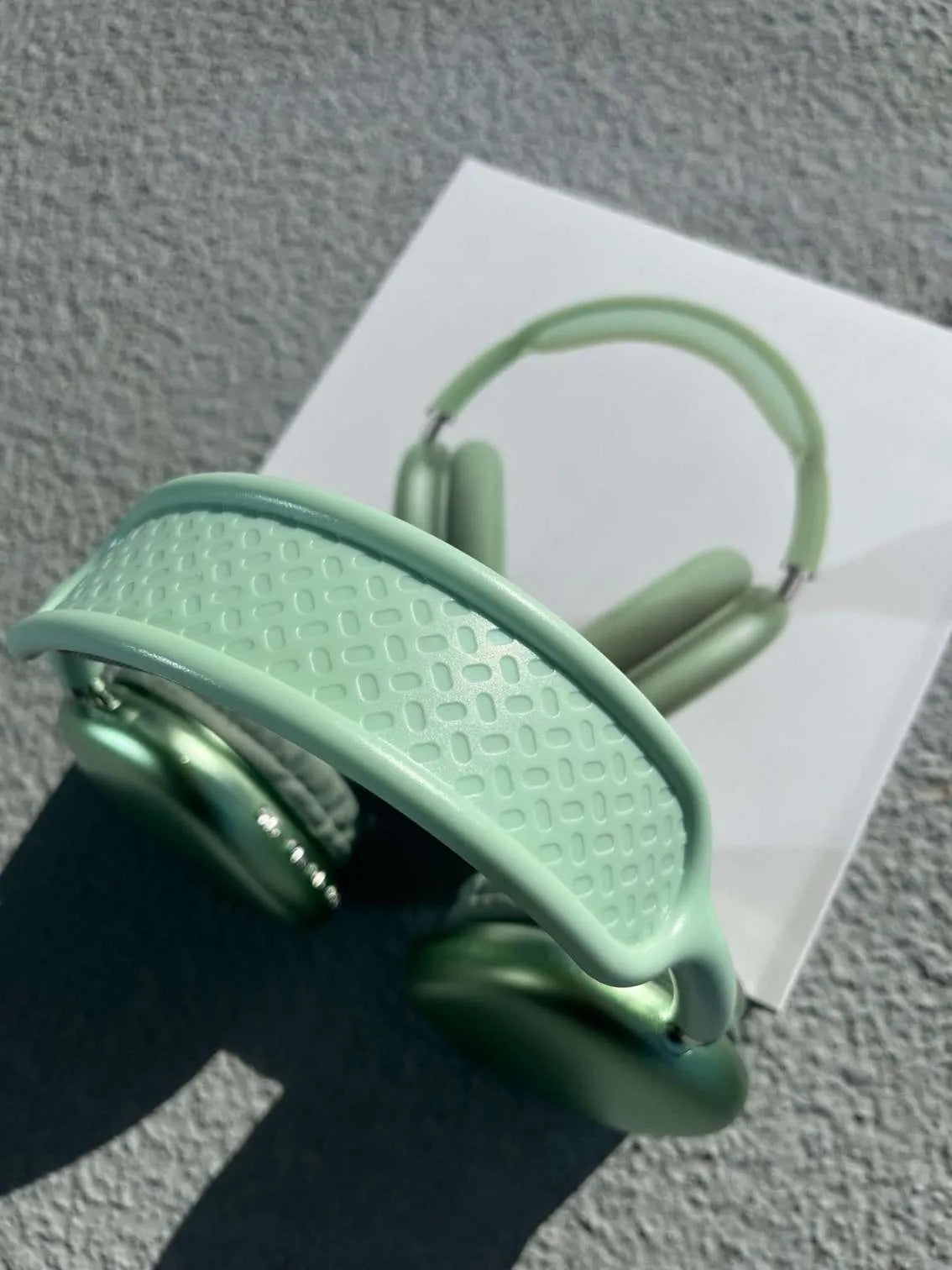 Top view of green over-ear Bluetooth headphones.