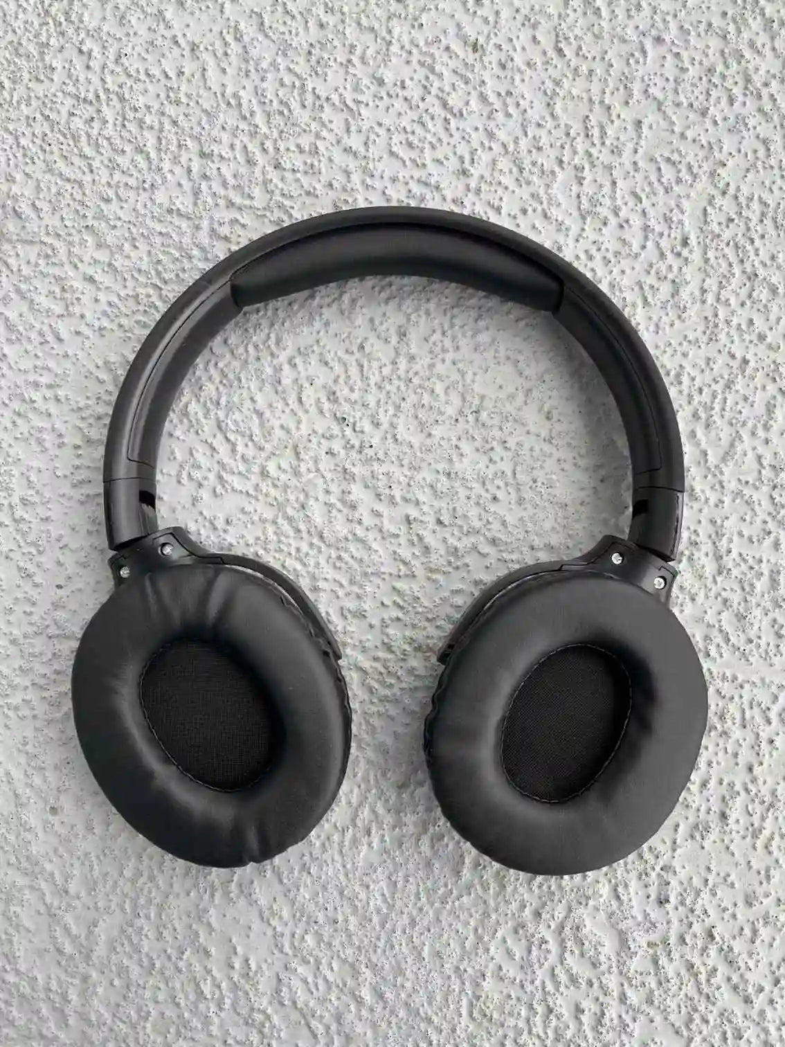 Black over-ear headphones featuring soft ear cushions for enhanced comfort and premium audio experience.