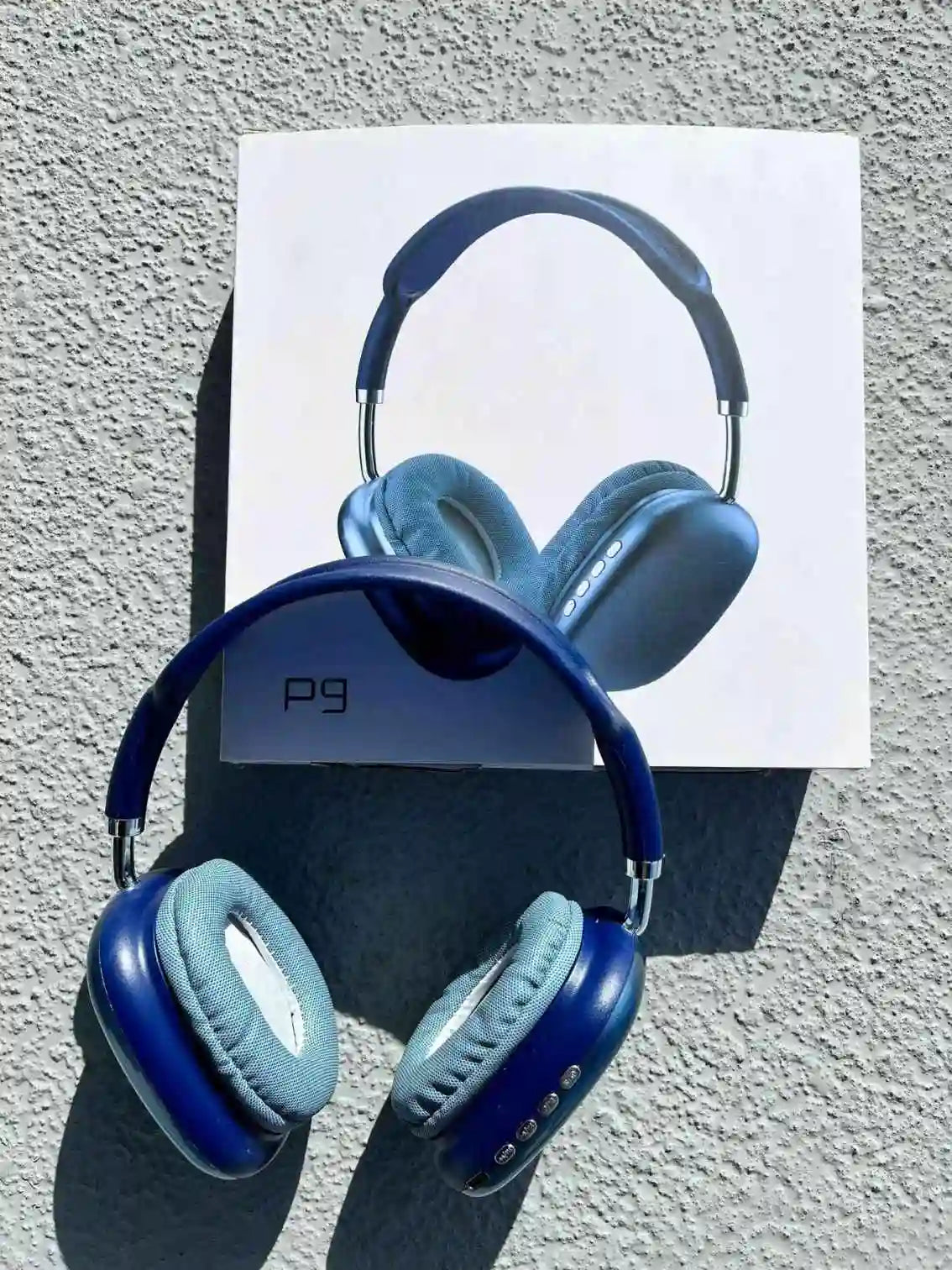 Stylish wireless over-ear p9 headphones, in blue colour, on the box.