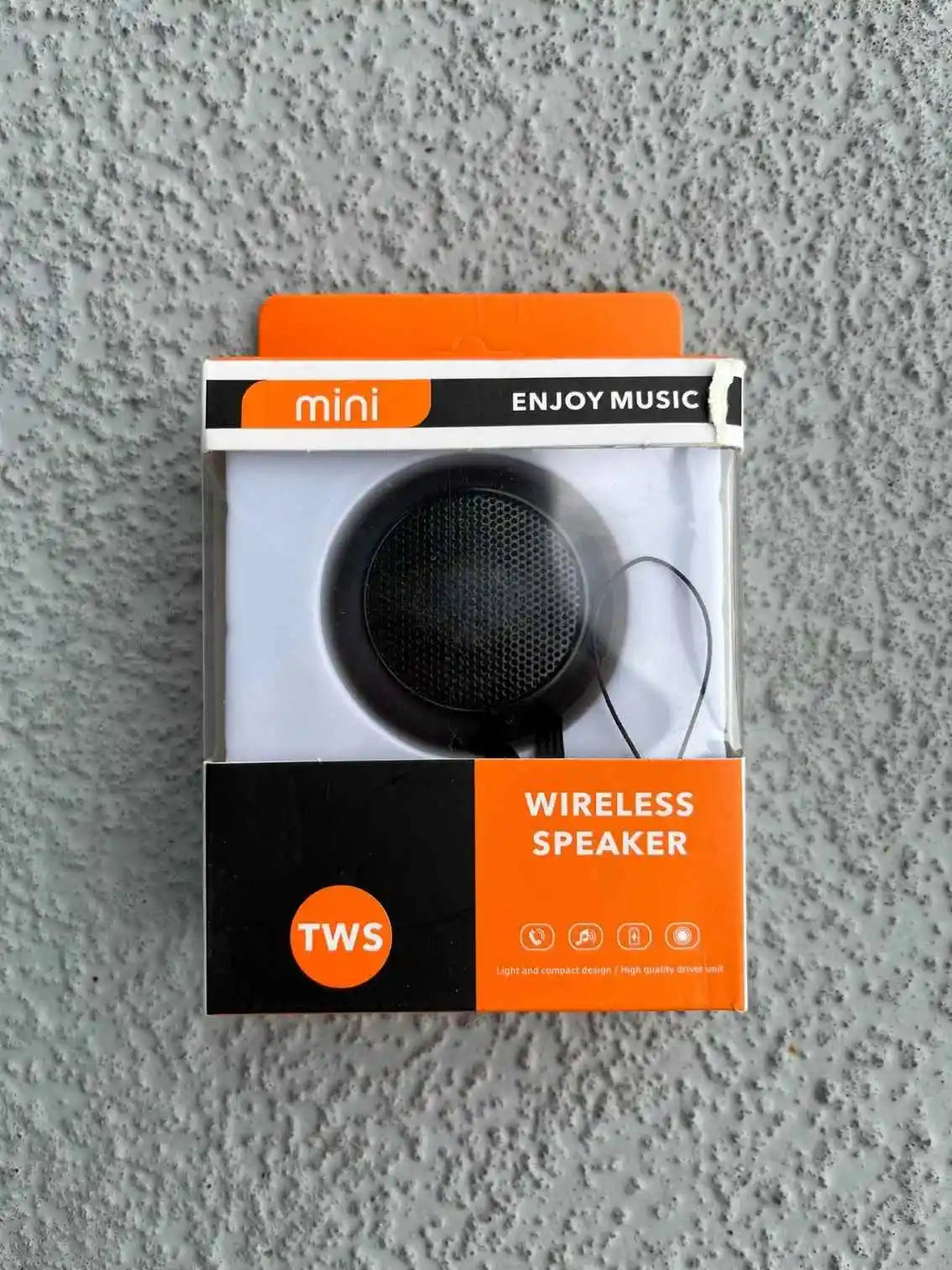 Packaging of black mini wireless speaker.