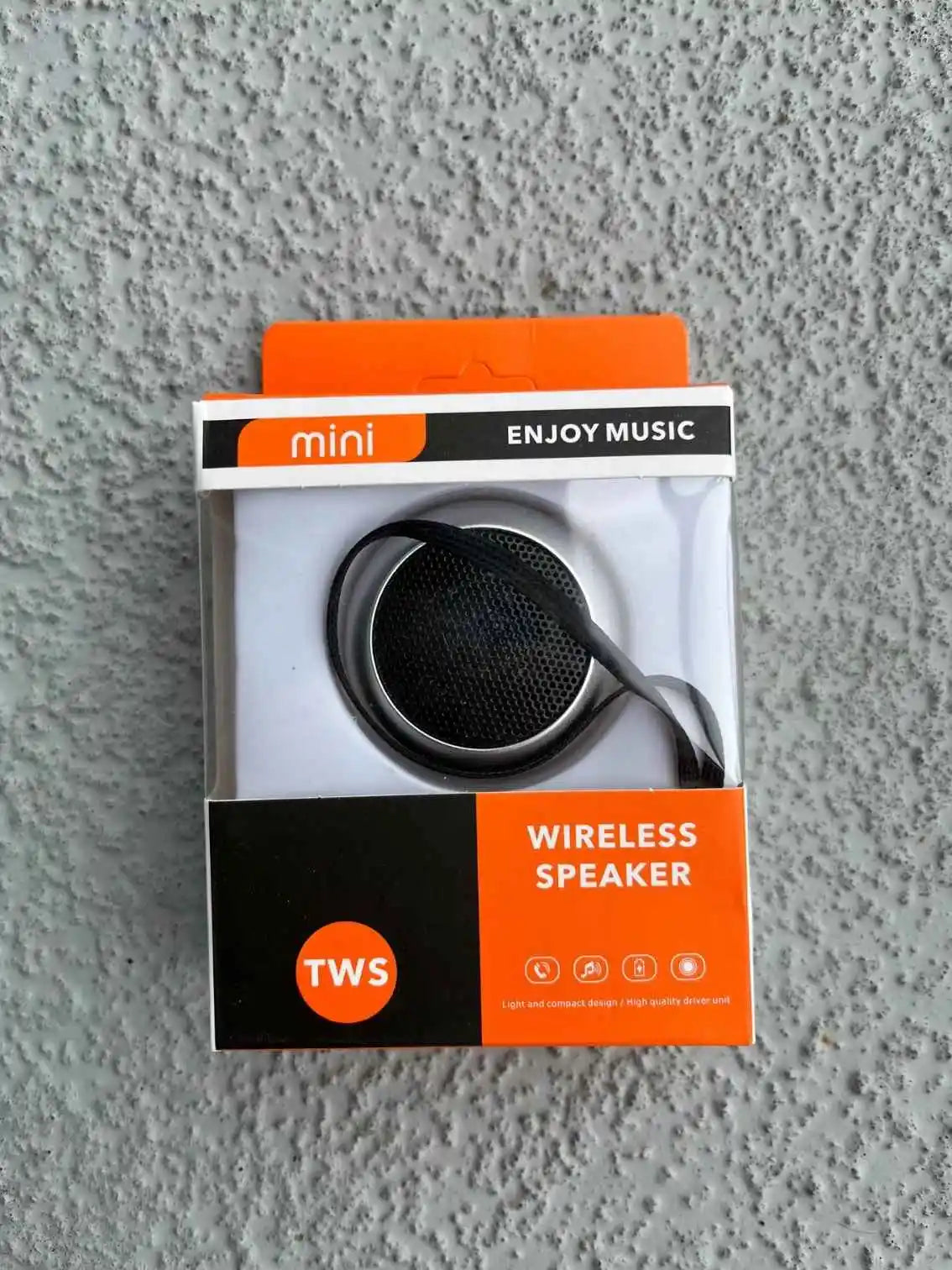 Mini Bluetooth speaker in silver packaging.