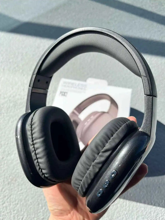 Wireless headphones PG02 in black colour held in hand.