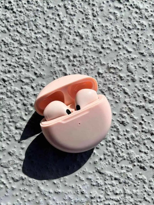 Stylish wireless earphones in pink color, in a case.