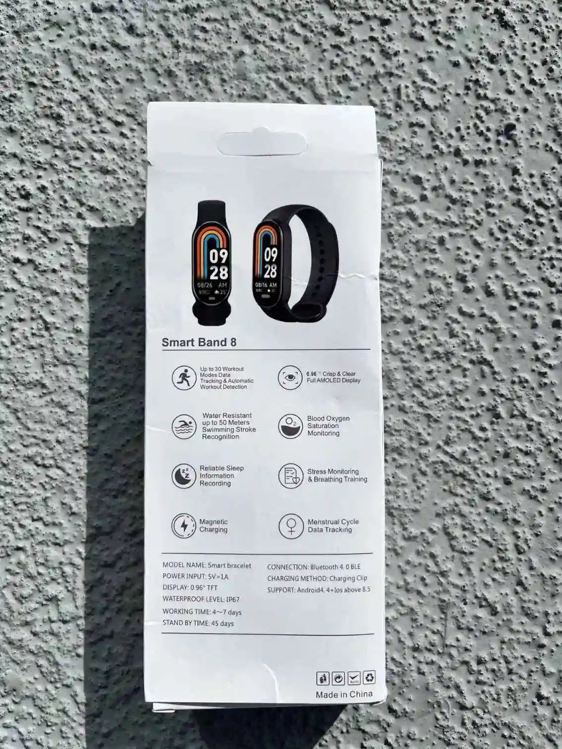 Smart Band 8 smartwatch box highlighting features, including heart rate monitoring, sleep tracking, and fitness activity tracking.