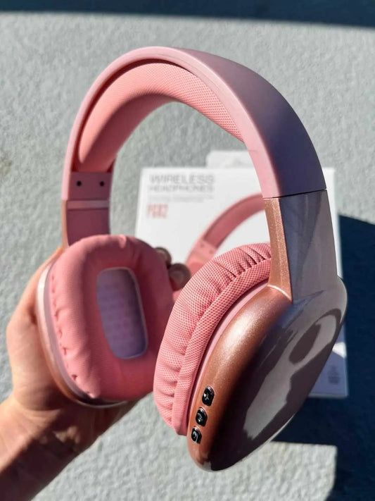 PG02 Wireless headphones in pink colour held in hand.