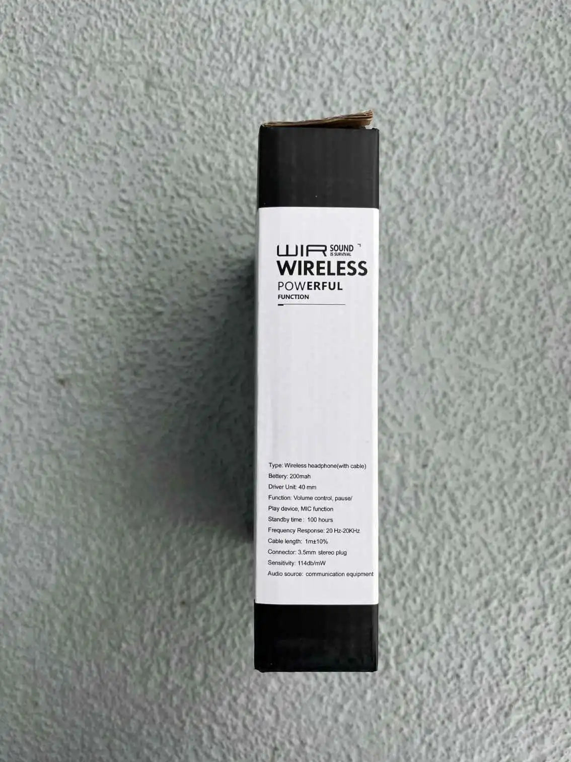 Side view of wireless headphones packaging with specifications and features.